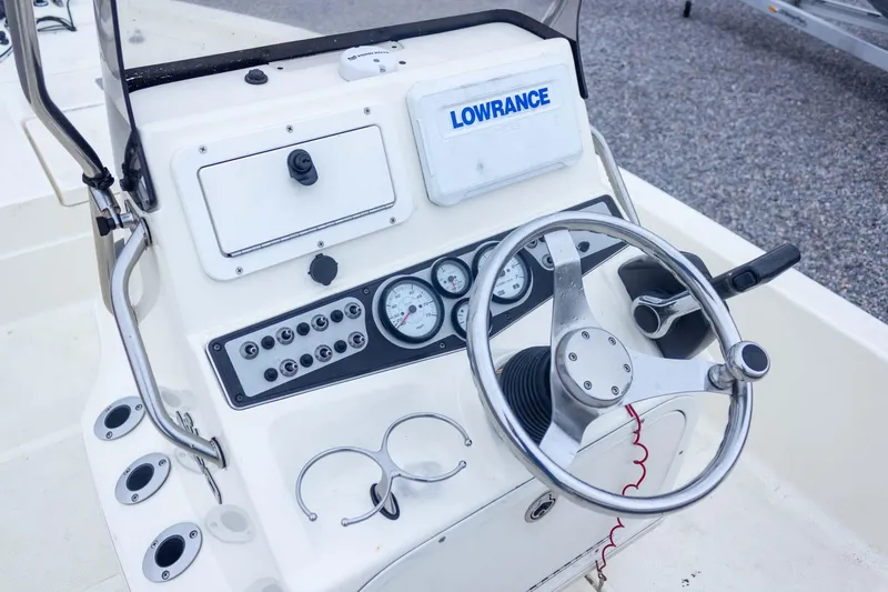 Slide: The Image of 2013 Skeeter SX210 boat dashboard with steering wheel and Lowrance navigation system. - 22