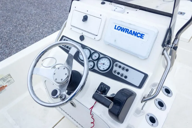 Slide: The Image of 2013 Skeeter SX210 boat dashboard with steering wheel and Lowrance navigation system. - 23