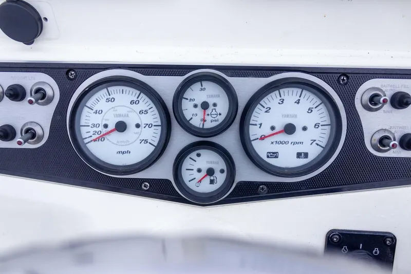 Slide: The Image of Dashboard of a 2013 Skeeter SX210 boat with Yamaha gauges and controls. - 24