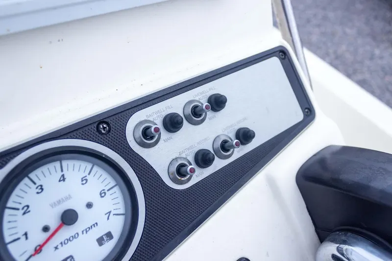 Slide: The Image of Control panel of 2013 Skeeter SX210 boat with Yamaha RPM gauge and switches. - 26