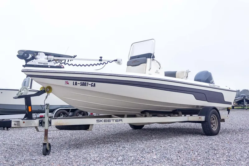 Slide: The Image of 2013 Skeeter SX210 boat on trailer, featuring Minn Kota trolling motor. - 4