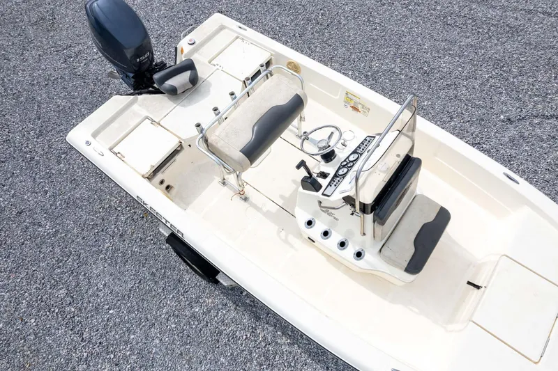Slide: The Image of 2013 Skeeter SX210 boat, aerial view of cockpit and controls on gravel surface. - 43