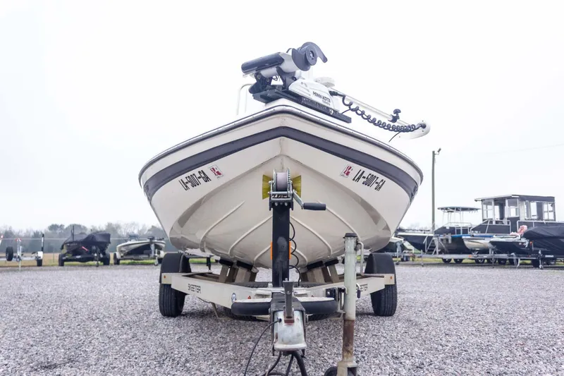 Slide: The Image of 2013 Skeeter SX210 boat on trailer in a gravel lot, front view. - 5
