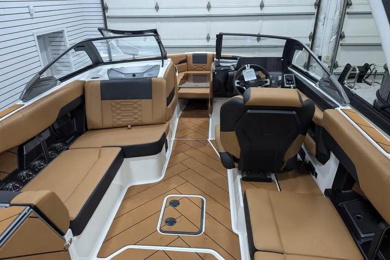 Slide: The Image of Luxurious interior of 2026 Malibu Wakesetter 26 LSV boat with tan seating and modern dashboard. - 10