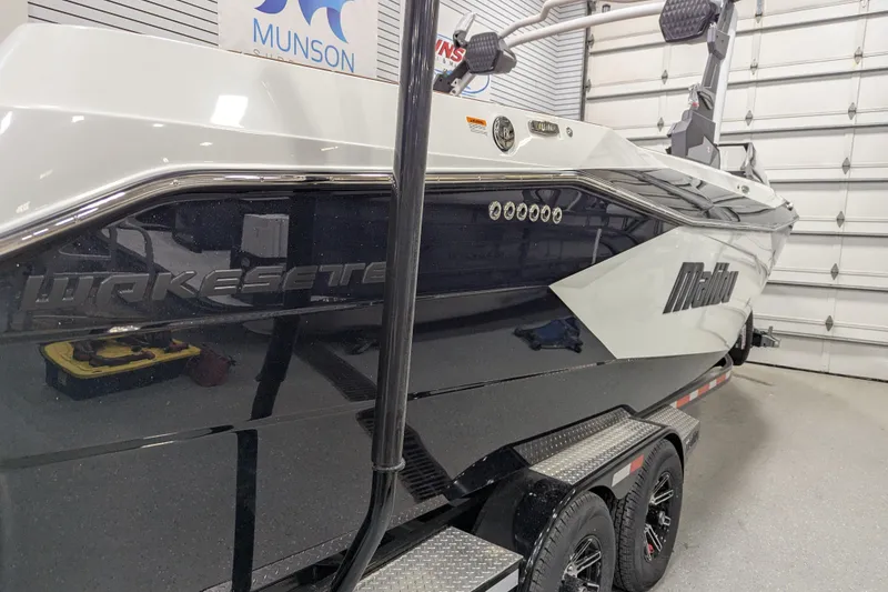 Slide: The Image of 2026 Malibu Wakesetter 26 LSV boat in a garage, side view. - 3