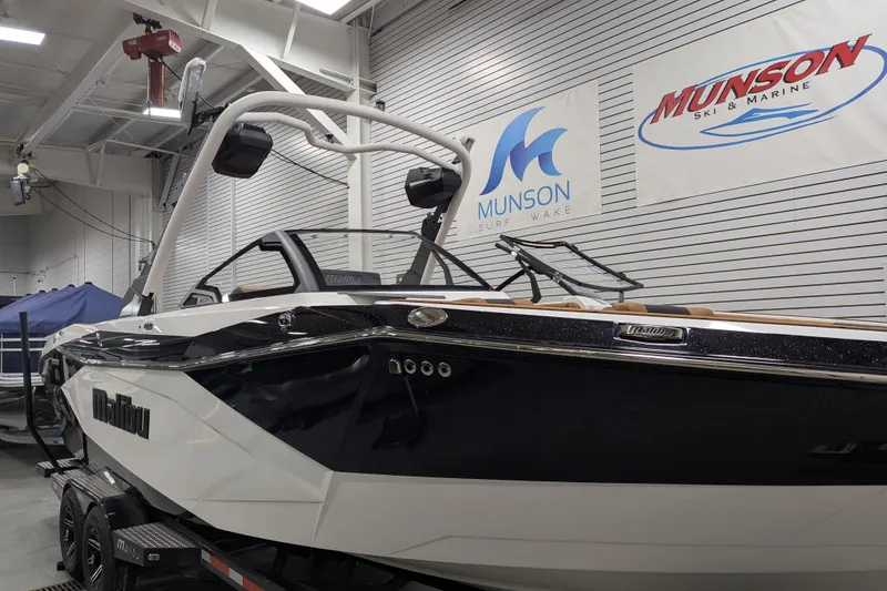 Slide: The Image of 2026 Malibu Wakesetter 26 LSV boat in showroom, Munson Ski & Marine signage visible. - 5