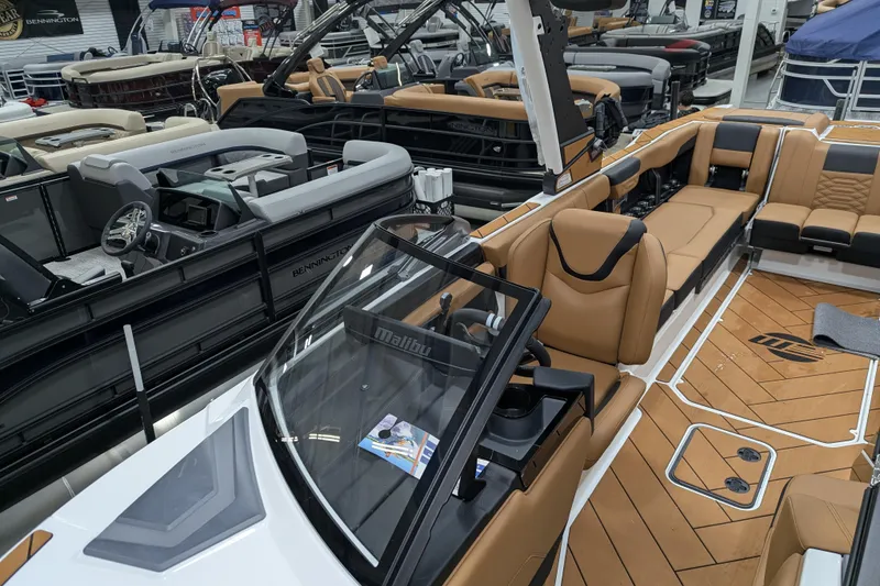 Slide: The Image of 2026 Malibu Wakesetter 26 LSV boat interior with tan seating and modern design. - 9