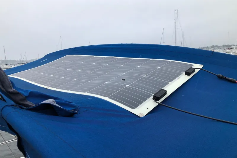 Slide: The Image of Solar panel on 1998 Catalina 320 sailboat, blue cover, marina background. - 18