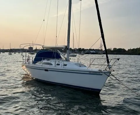 Slide: The Image of 1998 Catalina 320 sailboat on calm water at sunset. - 2