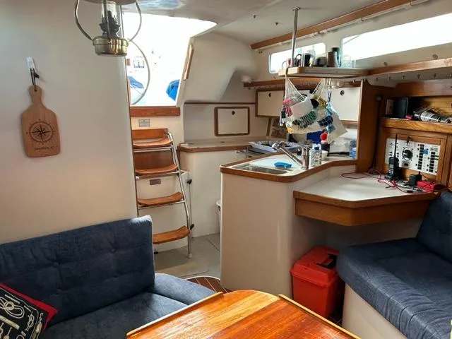 Slide: The Image of Interior of a 1998 Catalina 320 yacht with cozy seating area. - 22