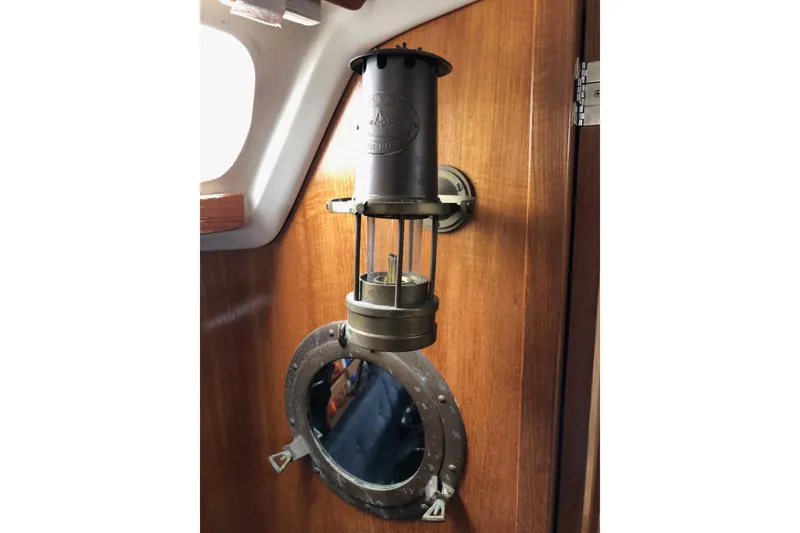 Slide: The Image of Vintage lantern and porthole on 1998 Catalina 320 sailboat interior. - 26