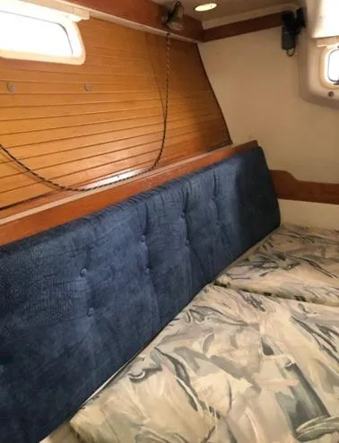 Slide: The Image of Interior of a 1998 Catalina 320 yacht with blue upholstery. - 27