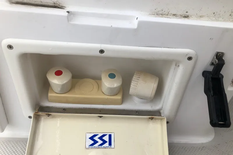 Slide: The Image of Control panel on a 1998 Catalina 320 boat with red and blue knobs. - 33