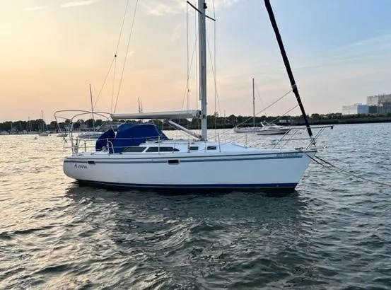 Slide: The Image of 1998 Catalina 320 sailboat on calm water at sunset. - 4