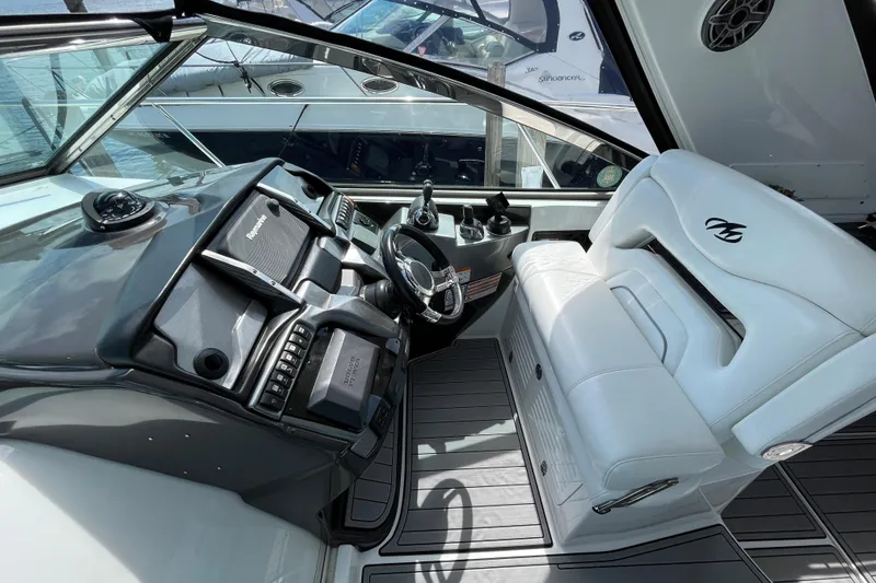 Slide: The Image of Cockpit of 2015 Monterey 415 Sport Yacht with modern controls and white seating. - 10
