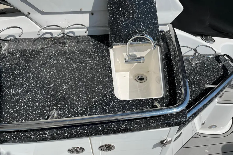 Slide: The Image of 2015 Monterey 415 Sport Yacht sink with speckled countertop and chrome fixtures. - 13