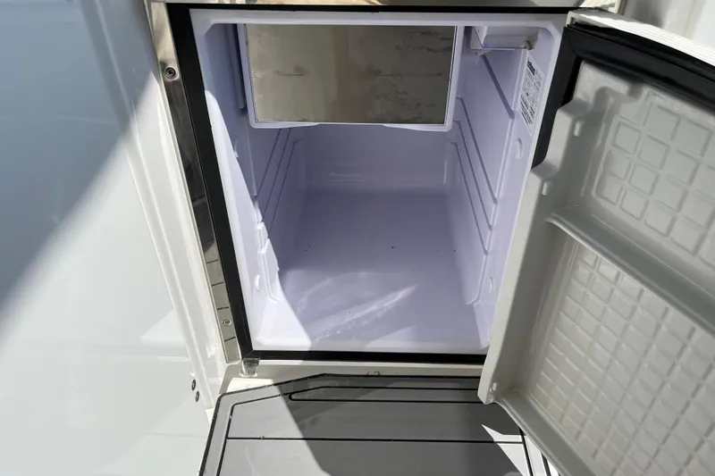 Slide: The Image of Open refrigerator on 2015 Monterey 415 Sport Yacht, showcasing interior storage space. - 15