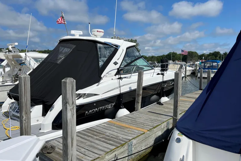 Slide: The Image of 2015 Monterey 415 Sport Yacht docked at marina under blue sky. - 2