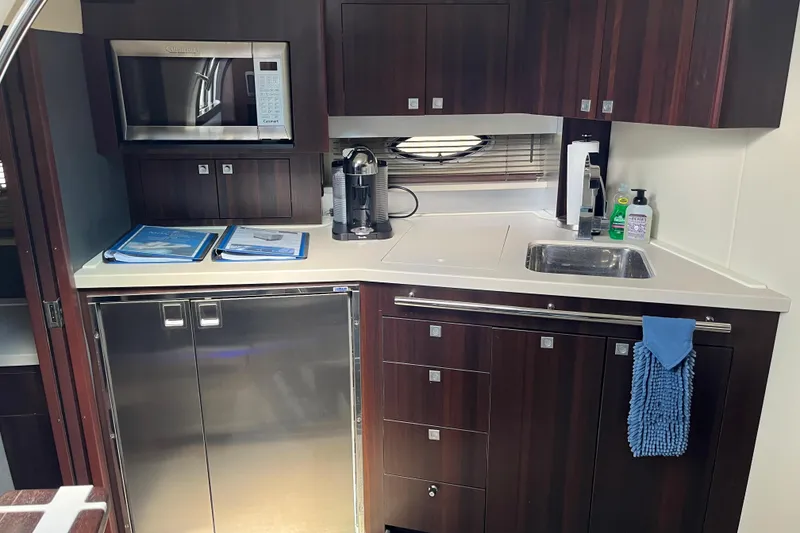 Slide: The Image of Luxurious kitchen area in a 2015 Monterey 415 Sport Yacht with modern appliances. - 21