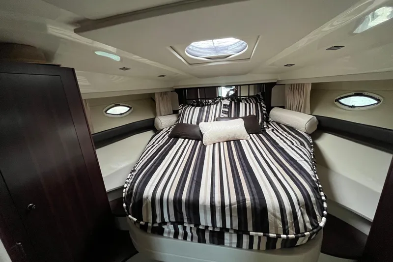 Slide: The Image of Luxurious cabin interior of 2015 Monterey 415 Sport Yacht with striped bedding. - 24