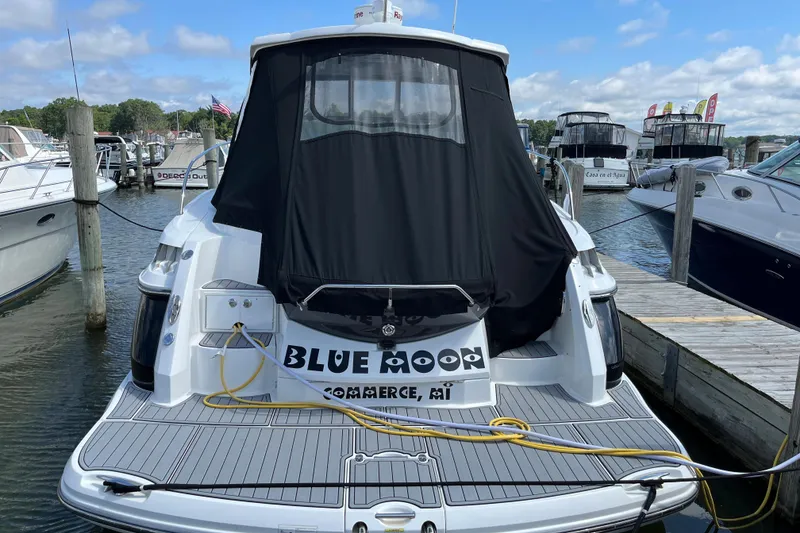 Slide: The Image of 2015 Monterey 415 Sport Yacht docked, rear view with cover, in a marina setting. - 4
