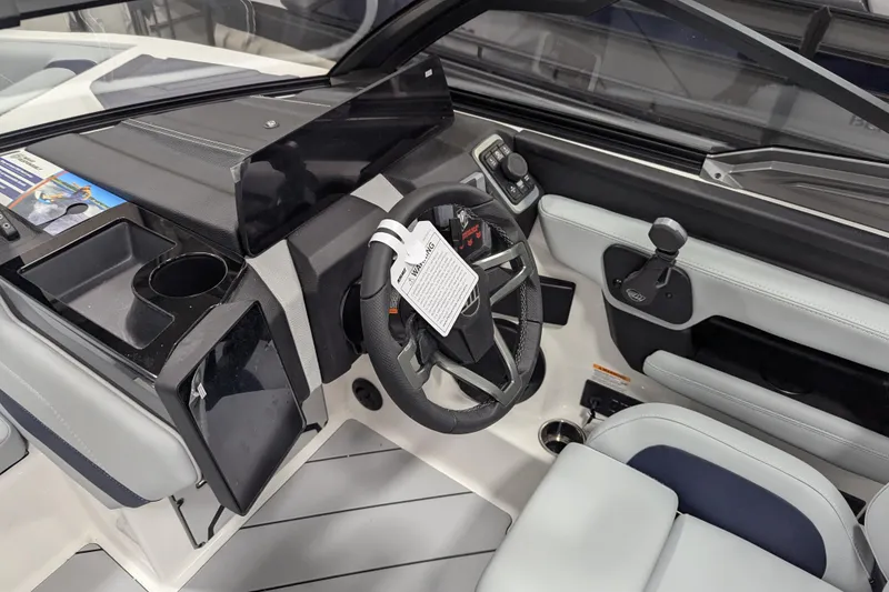 Slide: The Image of 2026 Malibu Wakesetter 23 LSV boat interior with steering wheel and dashboard controls. - 10