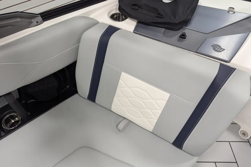Slide: The Image of 2026 Malibu Wakesetter 23 LSV interior seating with stylish upholstery and cup holders. - 11