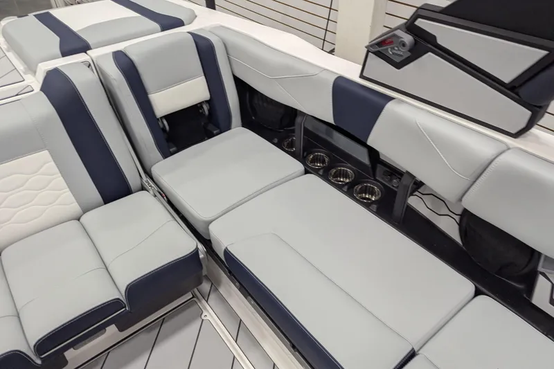 Slide: The Image of 2026 Malibu Wakesetter 23 LSV interior with luxurious seating and cup holders. - 13