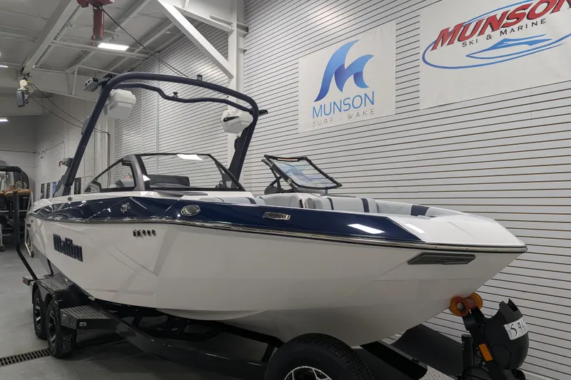 Slide: The Image of 2026 Malibu Wakesetter 23 LSV boat in showroom, Munson Surf & Wake signage. - 5