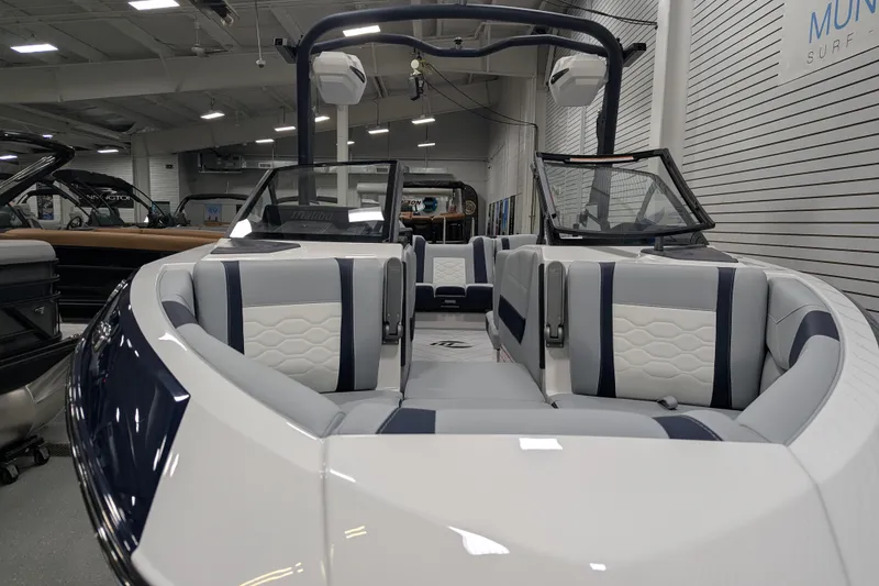 Slide: The Image of 2026 Malibu Wakesetter 23 LSV boat interior with sleek seating design in showroom. - 6