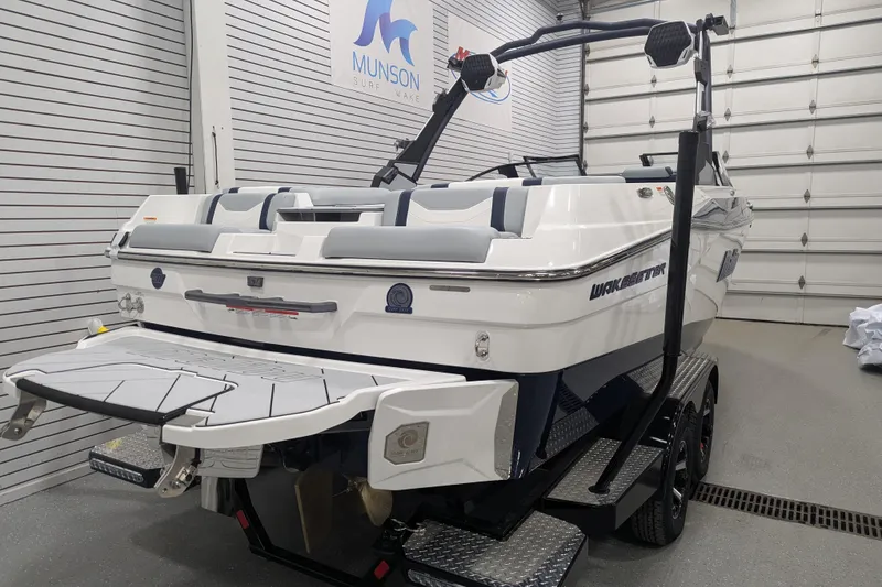 Slide: The Image of 2026 Malibu Wakesetter 23 LSV boat in showroom, rear view, on trailer. - 7