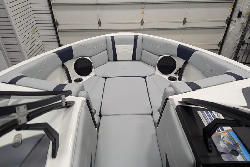 Slide: The Image of 2026 Malibu Wakesetter 23 LSV boat interior with cushioned seating and cup holders. - 9