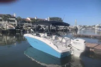Slide: The Image of 2025 Hurricane SunDeck 2050 OB boat docked in a serene marina setting. - 3