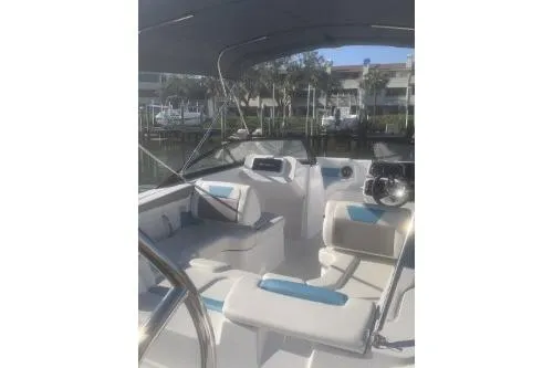 Slide: The Image of 2025 Hurricane SunDeck 2050 OB boat interior with seating and steering wheel. - 5