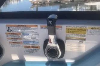Slide: The Image of 2025 Hurricane SunDeck 2050 OB boat control panel with warning labels and throttle lever. - 8