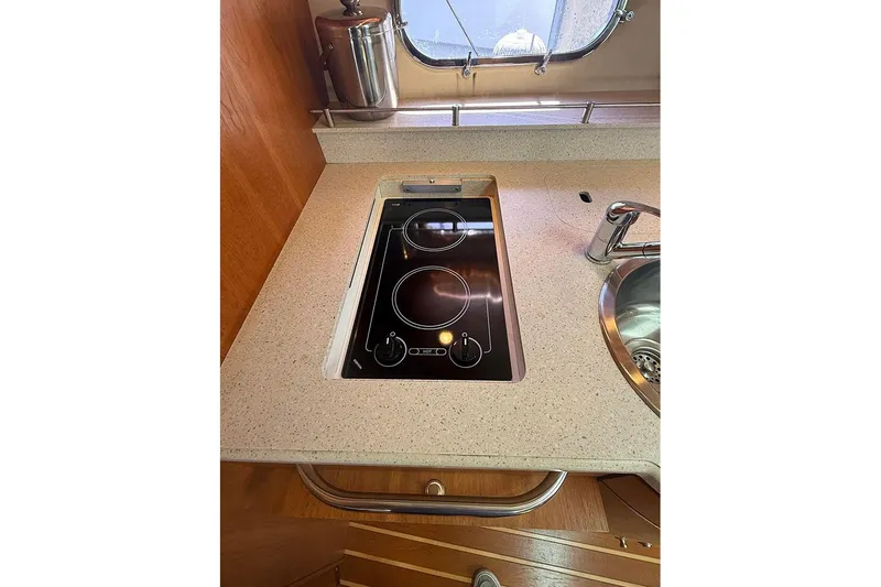 Slide: The Image of 2008 Tiara Yachts 3900 Sovran kitchen with electric stove and sink. - 13