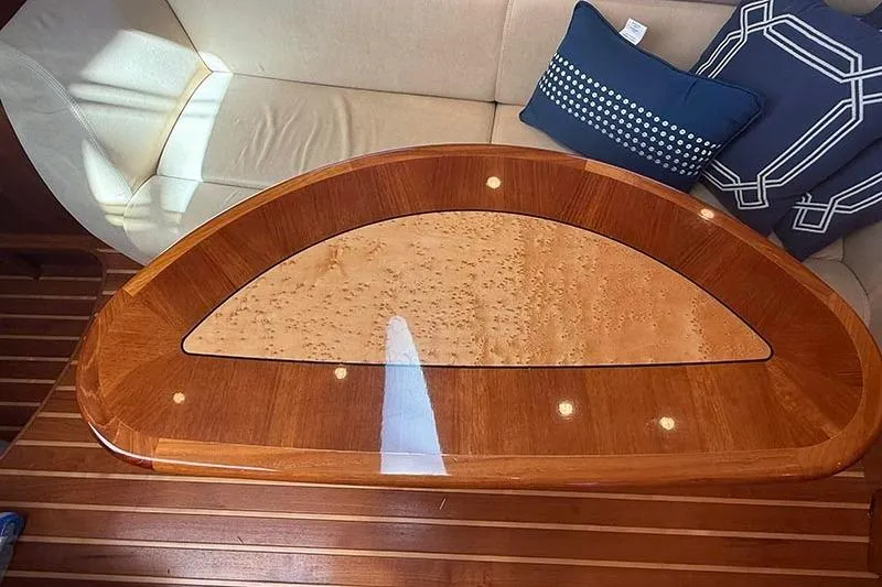 Slide: The Image of Luxurious wooden table on 2008 Tiara Yachts 3900 Sovran, with elegant seating and cushions. - 16