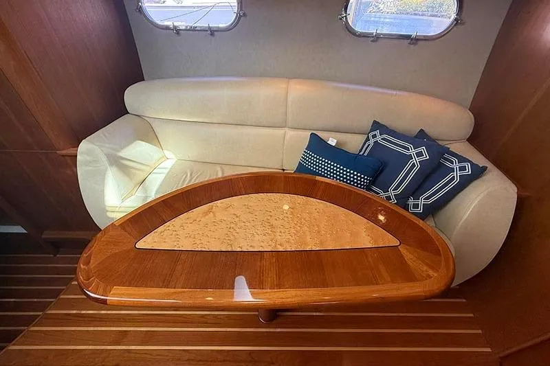Slide: The Image of 2008 Tiara Yachts 3900 Sovran interior with elegant wood table and plush seating. - 17