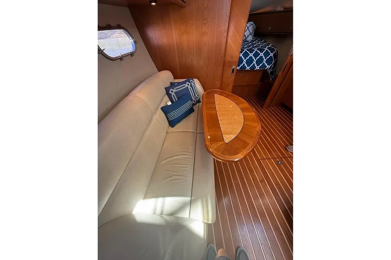 Slide: The Image of Interior of 2008 Tiara Yachts 3900 Sovran with beige sofa, wooden table, and nautical decor. - 18