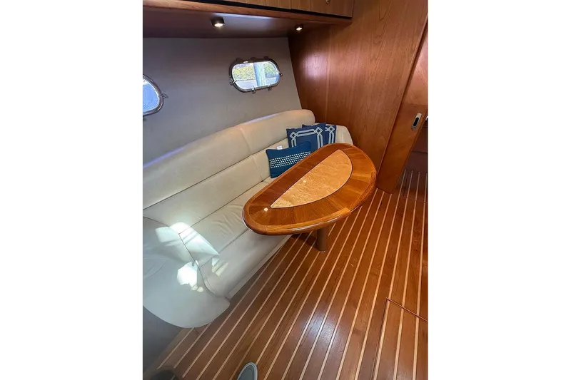Slide: The Image of 2008 Tiara Yachts 3900 Sovran interior with elegant wood table and cushioned seating. - 19