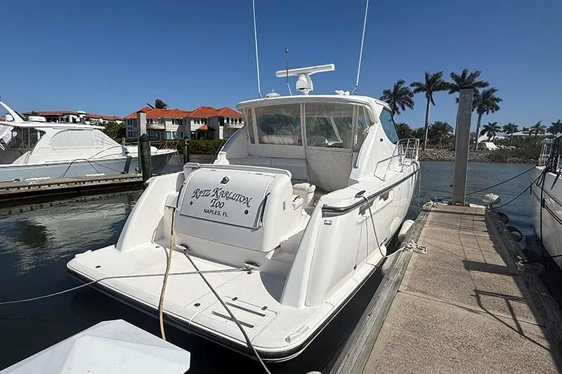 Slide: The Image of 2008 Tiara Yachts 3900 Sovran docked in sunny marina with palm trees. - 2