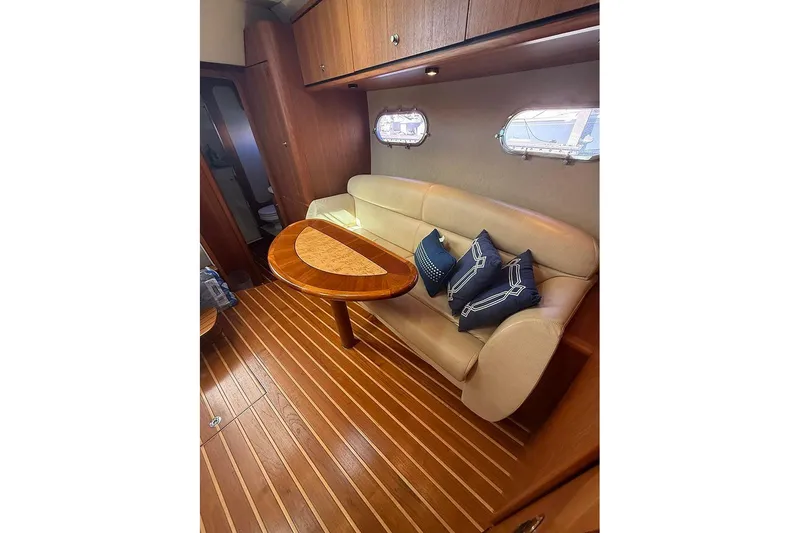 Slide: The Image of Interior of 2008 Tiara Yachts 3900 Sovran with elegant seating and wooden table. - 20