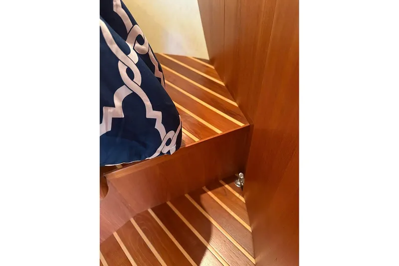 Slide: The Image of Wooden interior stairs of 2008 Tiara Yachts 3900 Sovran, featuring elegant striped design. - 21
