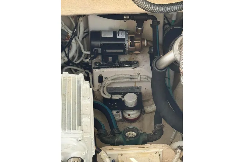 Slide: The Image of Engine compartment of 2008 Tiara Yachts 3900 Sovran, showcasing mechanical components and wiring. - 26
