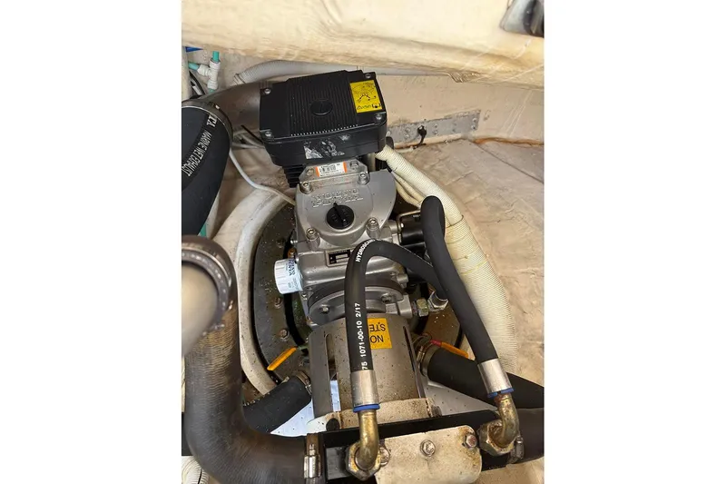 Slide: The Image of Engine compartment of a 2008 Tiara Yachts 3900 Sovran, showcasing mechanical components and hoses. - 35