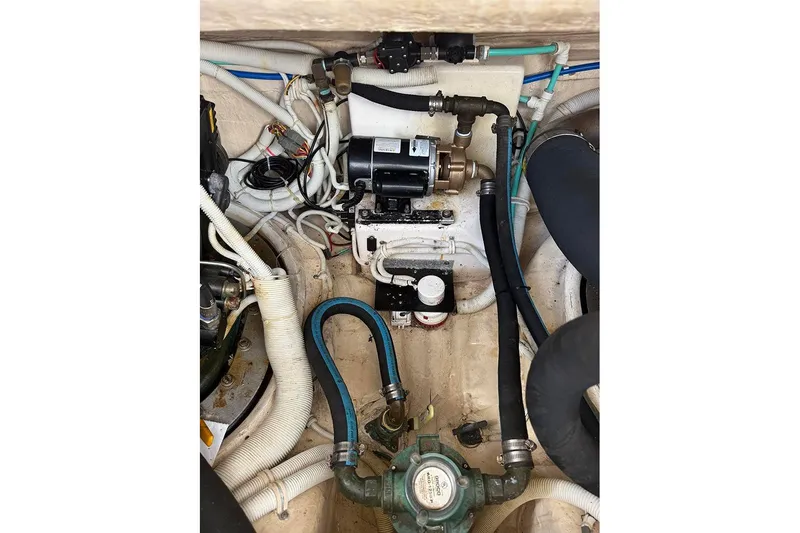 Slide: The Image of Engine compartment of a 2008 Tiara Yachts 3900 Sovran, showcasing mechanical components and hoses. - 36