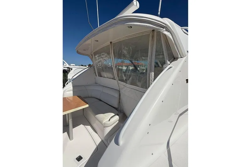 Slide: The Image of 2008 Tiara Yachts 3900 Sovran with white seating and table under clear canopy. - 39