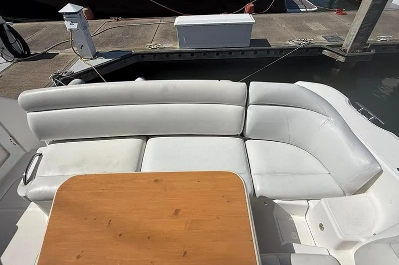 Slide: The Image of 2008 Tiara Yachts 3900 Sovran with white seating and wooden table on deck. - 40