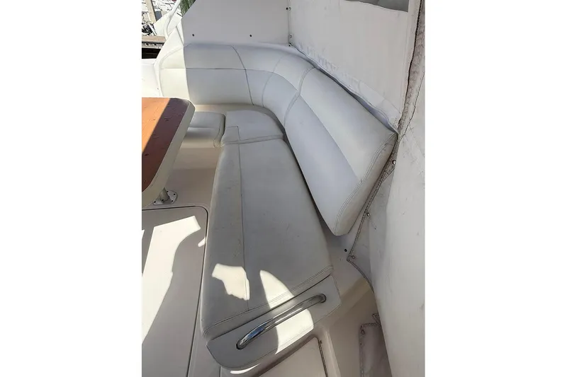 Slide: The Image of 2008 Tiara Yachts 3900 Sovran interior with white leather seating and wooden table. - 41