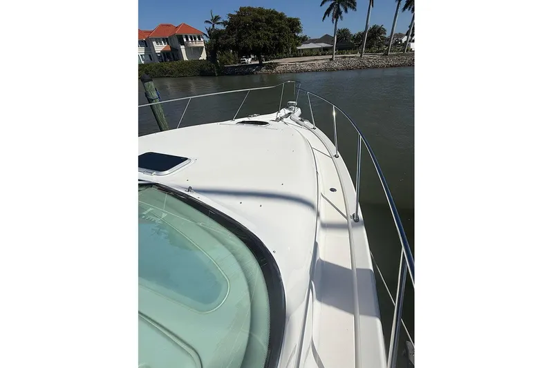 Slide: The Image of 2008 Tiara Yachts 3900 Sovran boat deck with railing, docked near waterfront homes. - 43